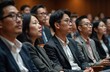 © Vadym - Asian people listen panel discussion sitting in amphitheater. Young audience watches seminar, meeting, presentation. Teamwork, education, conference, convention. Diverse group listens to business