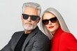 © PaulShlykov - Stylish older couple wearing sunglasses, showcasing modern fashion trends
