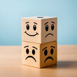 © Henry - Photo of a wooden cube with happy and sad face expressions as a symbol of instat personality shifts. Concept of bipolar , unipolar and borderline mental disorder.