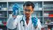 © Henry - The Asian smart man scientist is testing test tube.