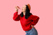 © Pixel-Shot - Happy young woman eating tasty pizza on pink background