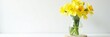 © Sathaporn Buarabut - Yellow daffodils in a clear glass jug with a natural stone base on white background, garden, flowers