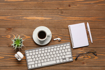 Wall Mural - computer keyboard, cup of coffee and notebook on wooden background