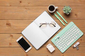 Wall Mural - composition with computer keyboard, cup of coffee and notebook on wooden background