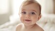 © EIKOZ - Close-up of a beautiful smiling baby with soft natural light and warm cozy atmosphere