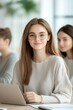 © Platoo studio - young woman with glasses working on laptop in bright office environment