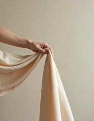 Aufkleber - Woman hand holds soft flowing beige fabric. Silk or chiffon sheer material with elegant drape. Smooth light airy texture in neutral cream colors. Style fashion minimal simple abstract.