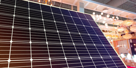 Wall Mural - solar panel and various types of light bulbs in an electrical appliance store. alternative renewable