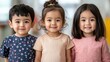© Adul khotchasri - Inclusive classroom collaboration teaching concept. Three smiling children pose together, showcasing their adorable outfits and cheerful expressions in a bright, welcoming environment.