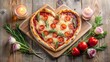 © NongPim - Heart-shaped pizza with rosemary and tomatoes on a wooden board, surrounded by candles and flowers, creating a romantic ambiance