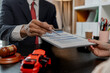 © kamiphotos - a lawyer is explaining the details of a car insurance policy to the car owner before she signs it, a lawyer explains to his client what will happen if she doesn't get car insurance