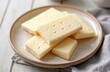 © miss irine - Macro shot vanilla wafers on plate. Rectangular biscuits with small holes, sweet snack. Crispy dessert served on table. Delicious baked treat, ideal for breakfast with coffee, tea.
