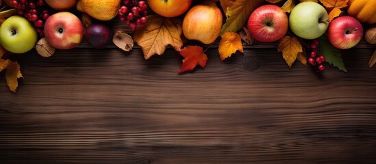 Poster - Autumn wooden backdrop showcasing vibrant leaves pumpkins apples and pears in rich oranges and greens with ample copy space on a dark wood surface