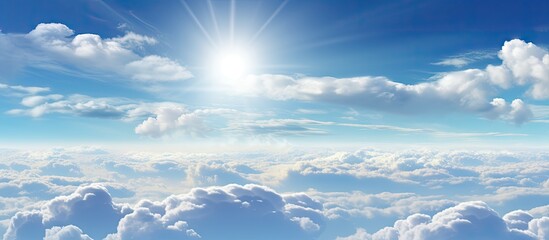 Poster - Expansive blue sky with bright sun rays illuminating fluffy white clouds offering ample copy space for nature-themed designs or advertisements.
