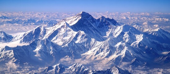 Aufkleber - Majestic snow-covered mountain peaks under a clear blue sky with dramatic shadowing and ridges, showcasing the beauty of Earth's highlands.