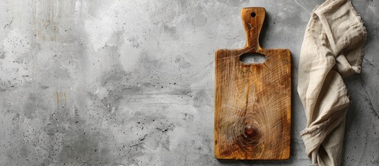Aufkleber - Wooden cutting board on a gray concrete surface with light fabric napkin positioned on the right creating ample minimalist copy space for text