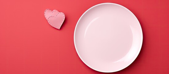 Poster - Valentine's Day top view featuring an empty pink plate positioned left on a vibrant red background with a pale pink heart on the right side