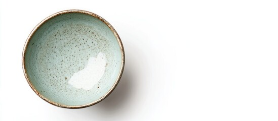 Poster - Ceramic bowl viewed from above featuring a light green and brown pattern on a white background, showcasing its unique handcrafted design.
