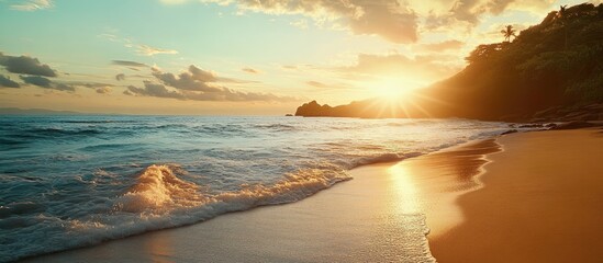 Aufkleber - Golden sunset illuminating a serene tropical beach with gentle waves, soft sand, lush greenery, and vibrant clouds reflecting warm hues.