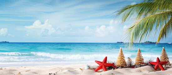 Aufkleber - Tropical beach scene with clear blue water, golden sand, decorative Christmas trees in pyramid shapes, and red starfish placed on the shore.