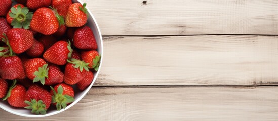 Poster - Fresh strawberries in a white bowl positioned on the left of a light wooden background with ample copy space on the right for text.