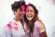 © AJay - Indian ethnic fun loving couple celebrating Holi festival with colours