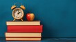 © warunthorn - Vintage Alarm Clock on Colorful Stacked Books with Apple