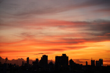 Wall Mural - The sky is orange and the sun is setting