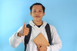 © Lailar Studio - Asian male student smiling while holding notebook
