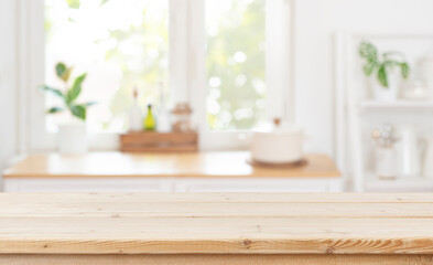 Wall Mural - wooden table top on blurred kitchen window interior background for product advertising
