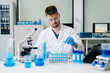 © Nuttapong punna - male scientist working with micro pipettes analyzing biochemical samples, advanced science