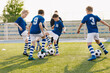 © matimix - Young boys playing soccer training game. Junior football practice competition between players running in a duel and kicking a soccer ball. Training and football match between youth soccer teams