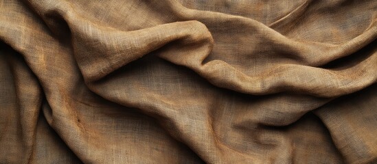 Aufkleber - Textured brown fabric draped elegantly showcasing soft creases and wrinkles with warm earthy tones and subtle variations in light and shadow.