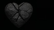 © Garadel - broken black heart shaped rock on dark background
