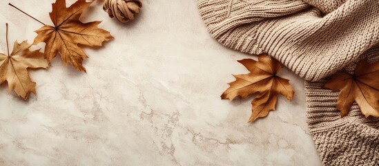 Aufkleber - Autumn aesthetic flat lay featuring brown maple leaves and a beige knitted sweater on a textured beige stone table minimalist fashion backdrop