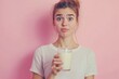 © Focus Gem - Young Woman Holding Glass of Milk Pink Background Healthy Lifestyle Girl Food Shot Cute Drink Dairy
