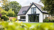 © Anna Studio - Modern house architecture, blending traditional architectural elements with contemporary design, featuring grand facade, large windows, manicured garden