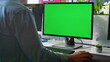 © stockbusters - Unknown freelancer working green screen computer in modern workplace closeup