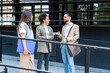 © Srdjan - Brainstorming. Group of young innovative business people, businessman and businesswoman standing out of office building, preparing for presentation at staff meeting with corporation management.