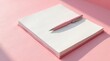 © Mali - Pink notebook and pen resting on a pink surface bathed in sunlight, ready for writing and ideas