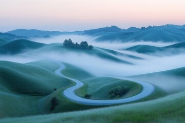 Aufkleber - Winding road through misty hills at dawn in a tranquil rural landscape surrounded by trees and soft fog