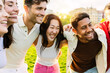 © Xavier Lorenzo - Young group of diverse friends having fun in a sunny day at city park. United millennial people laughing. Youth community concept