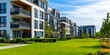 © inspiretta - Row of apartment buildings with a large green lawn in front of them.