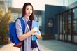 © BillionPhotos.com - A young happy woman student holds notebooks