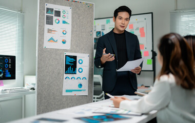 Poster - Asian businessman showing marketing research graphs and charts, presenting project ideas to colleagues in modern office