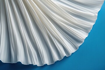 Poster - White fabric drapes gracefully against a vibrant blue background showcasing intricate texture and light