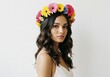© Nima - Woman with Floral Headcrown - A young woman with long brown wavy hair wears a vibrant flower crown. She's wearing a simple white dress against a white background