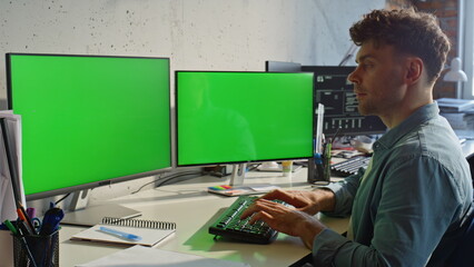 Designer working chromakey monitors typing computer keyboard at office closeup
