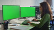 © stockbusters - Retoucher working greenscreen monitors typing computer keyboard office closeup