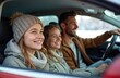 © miss irine - Happy family with two daughters travel by car in winter. Man drives auto, girls look at road smiling. Winter holidays road trip, father, children, family values concept.